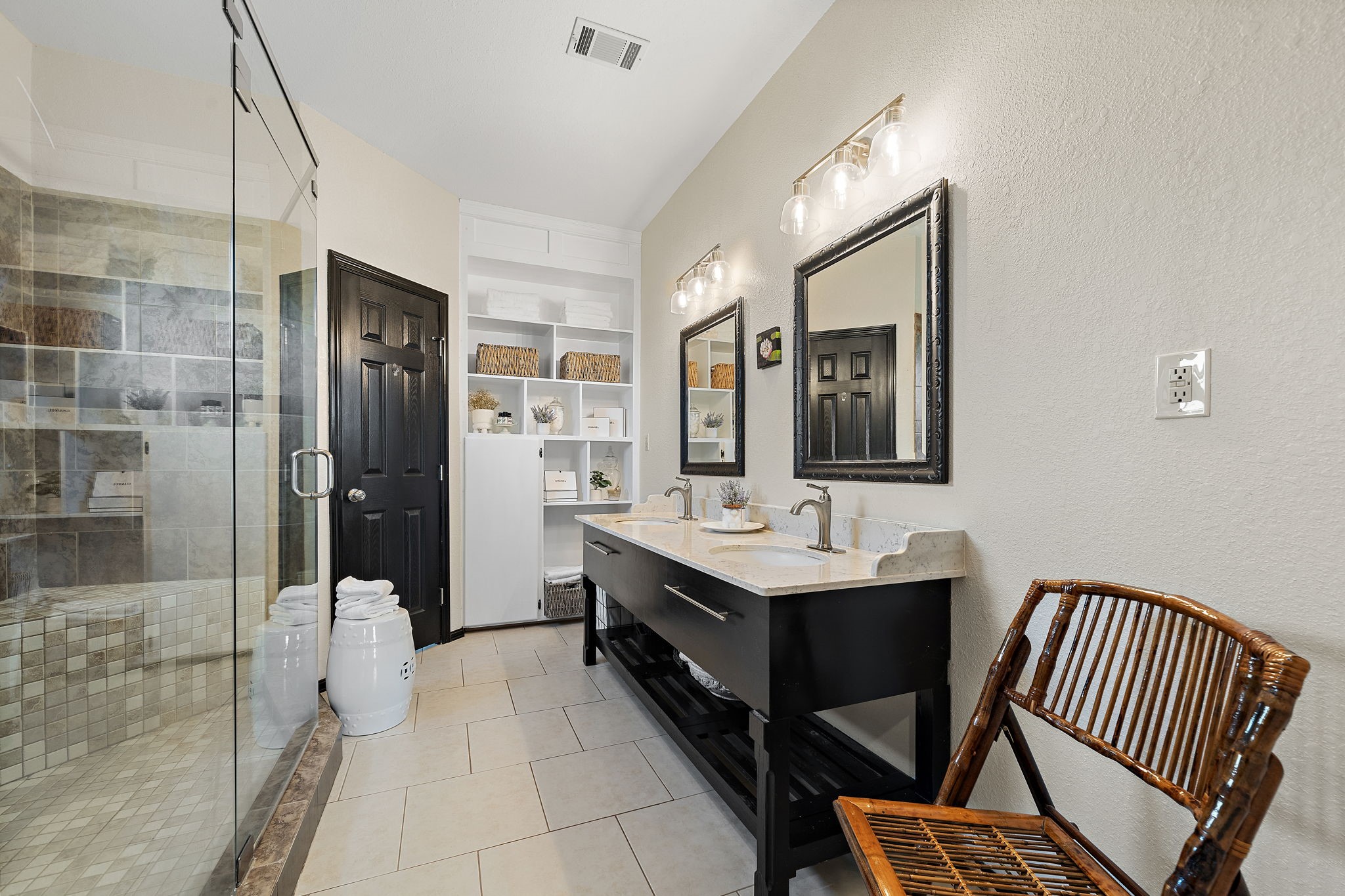 10411 County Road 65 Rosharon, TX 77583 - Photo 18 of 29 The primary en suite bathroom is equipped with elegant marble countertops and ample built-in storage, blending style with everyday function.