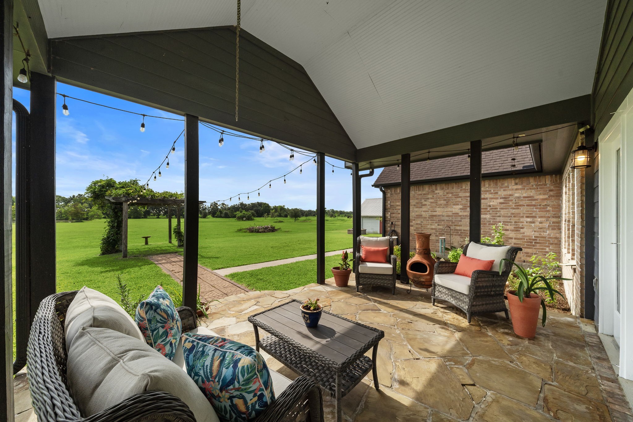 10411 County Road 65 Rosharon, TX 77583 - Photo 20 of 29 The covered back porch overlooks the wide-open yard and offers an ideal space for entertaining or enjoying a quiet cup of coffee.