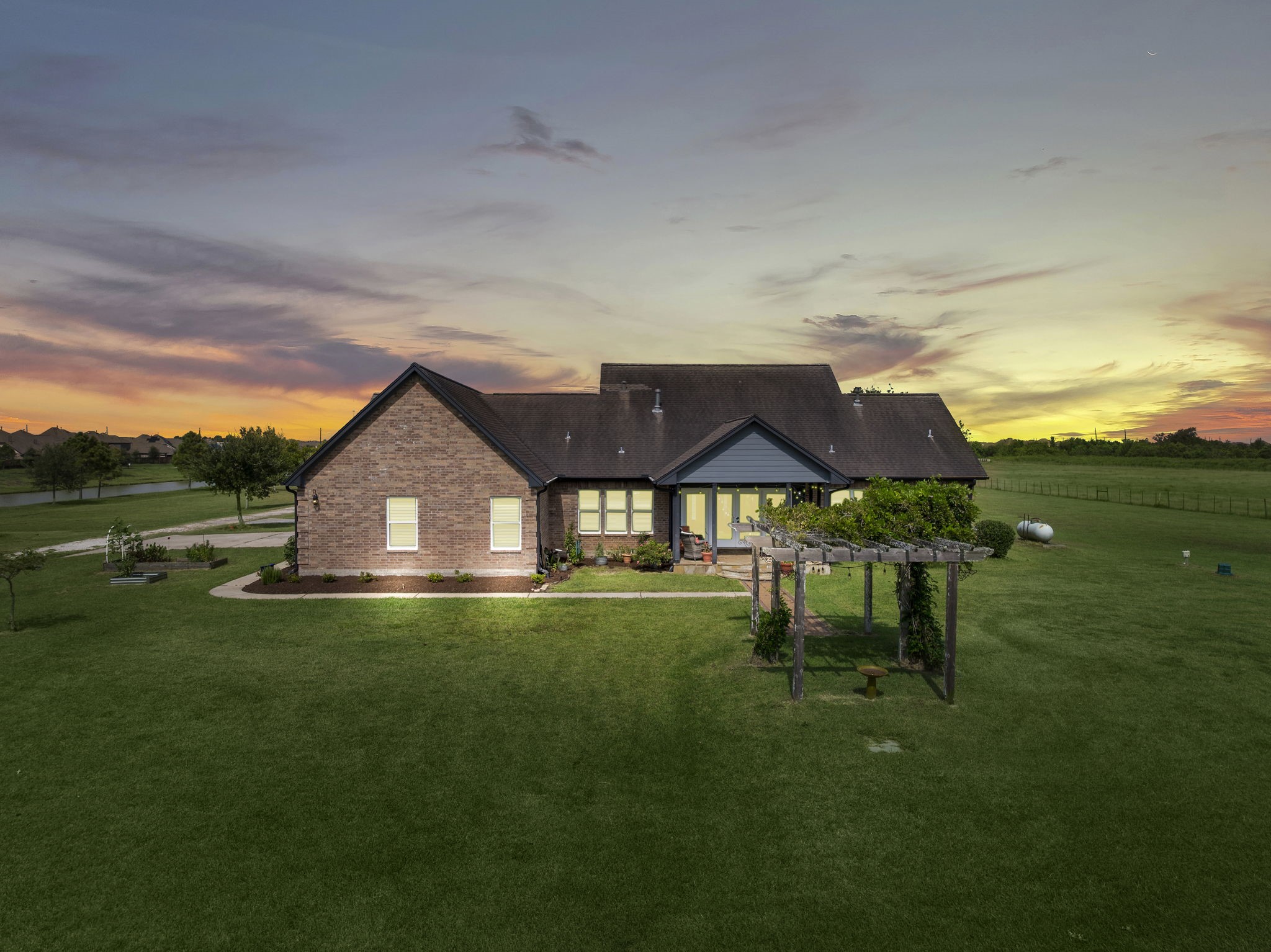 10411 County Road 65 Rosharon, TX 77583 - Photo 21 of 29 The backyard features a quaint garden, fire pit, and wide-open green space—perfect for quiet evenings or lively gatherings.