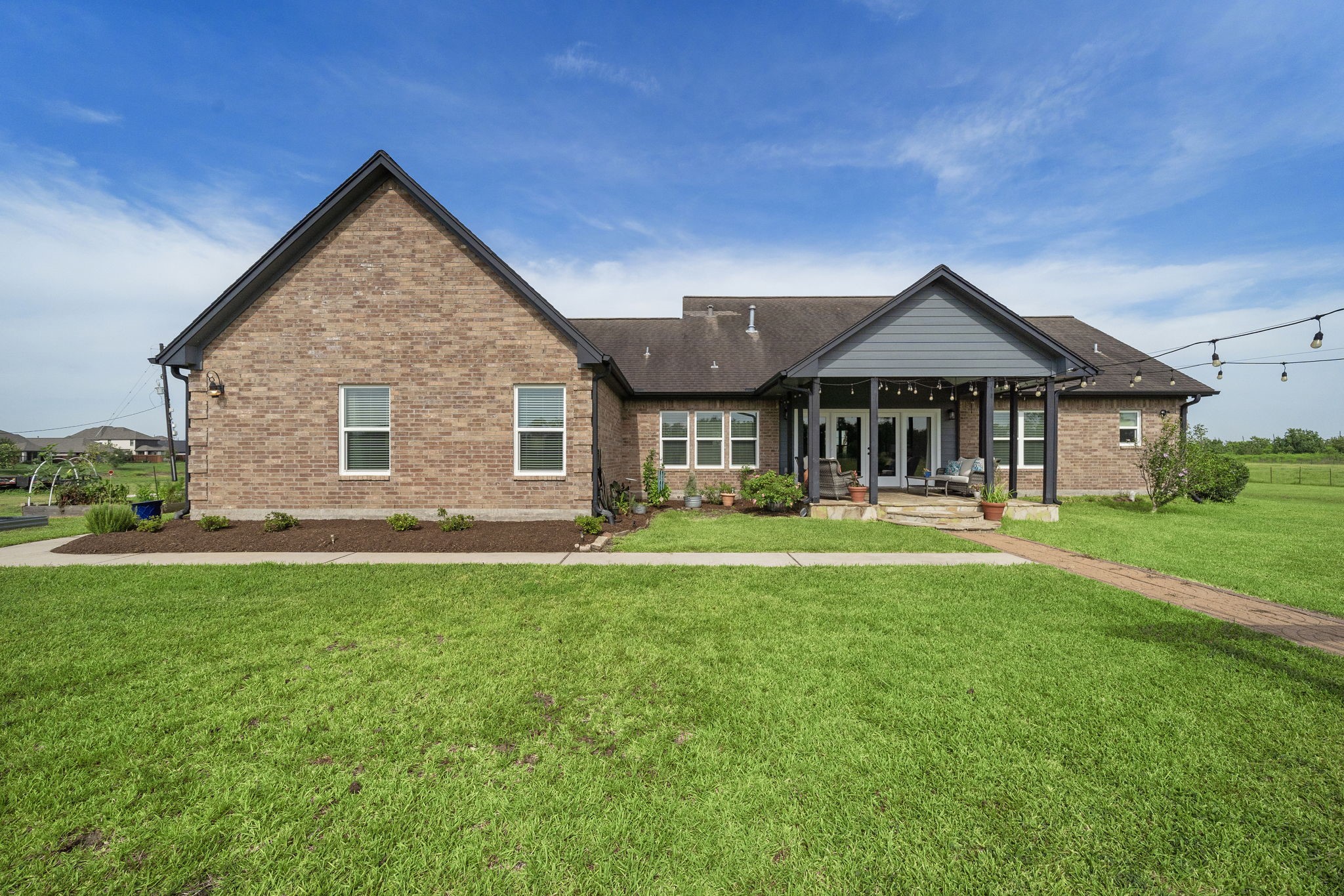 10411 County Road 65 Rosharon, TX 77583 - Photo 26 of 29 Thoughtfully designed landscaping surrounds the home, creating a seamless connection between the house and its expansive acreage.