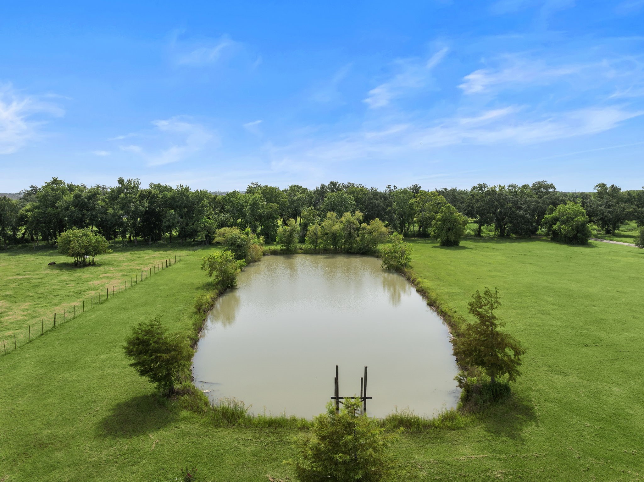 10411 County Road 65 Rosharon, TX 77583 - Photo 27 of 29 The serene pond at the back of the property is perfect for fishing and adds to the land’s peaceful, scenic setting.