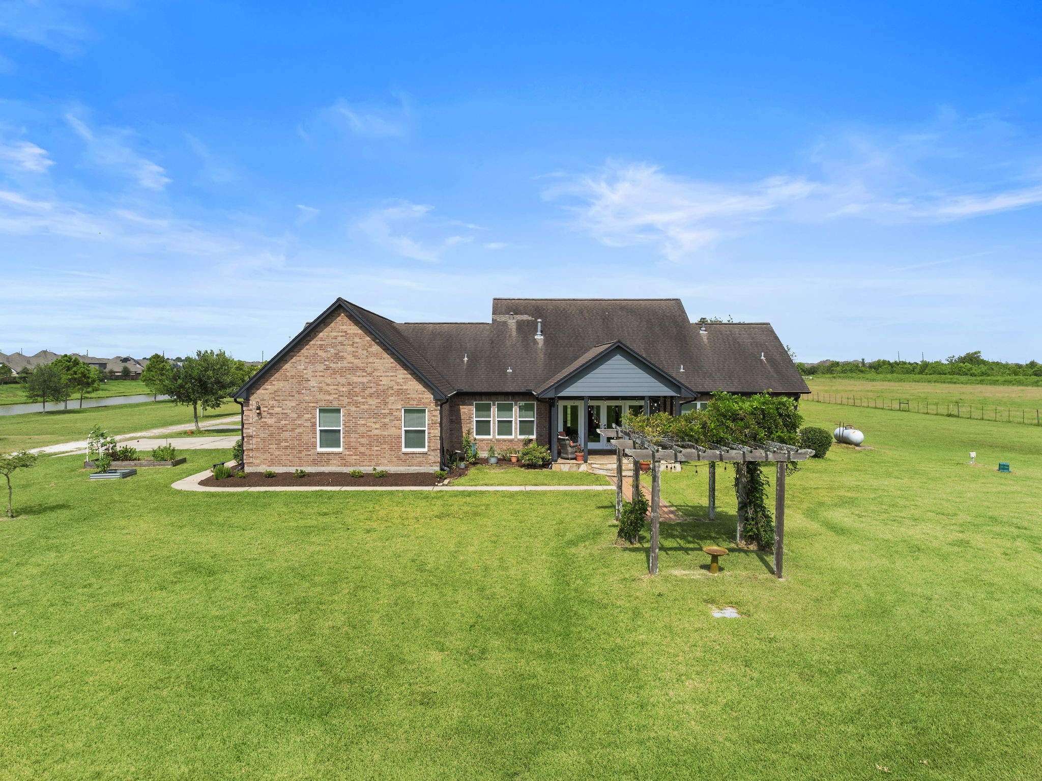 10411 County Road 65 Rosharon, TX 77583 - Photo 4 of 29 The backyard features a quaint garden, fire pit, and wide-open green space—perfect for quiet evenings or lively gatherings.
