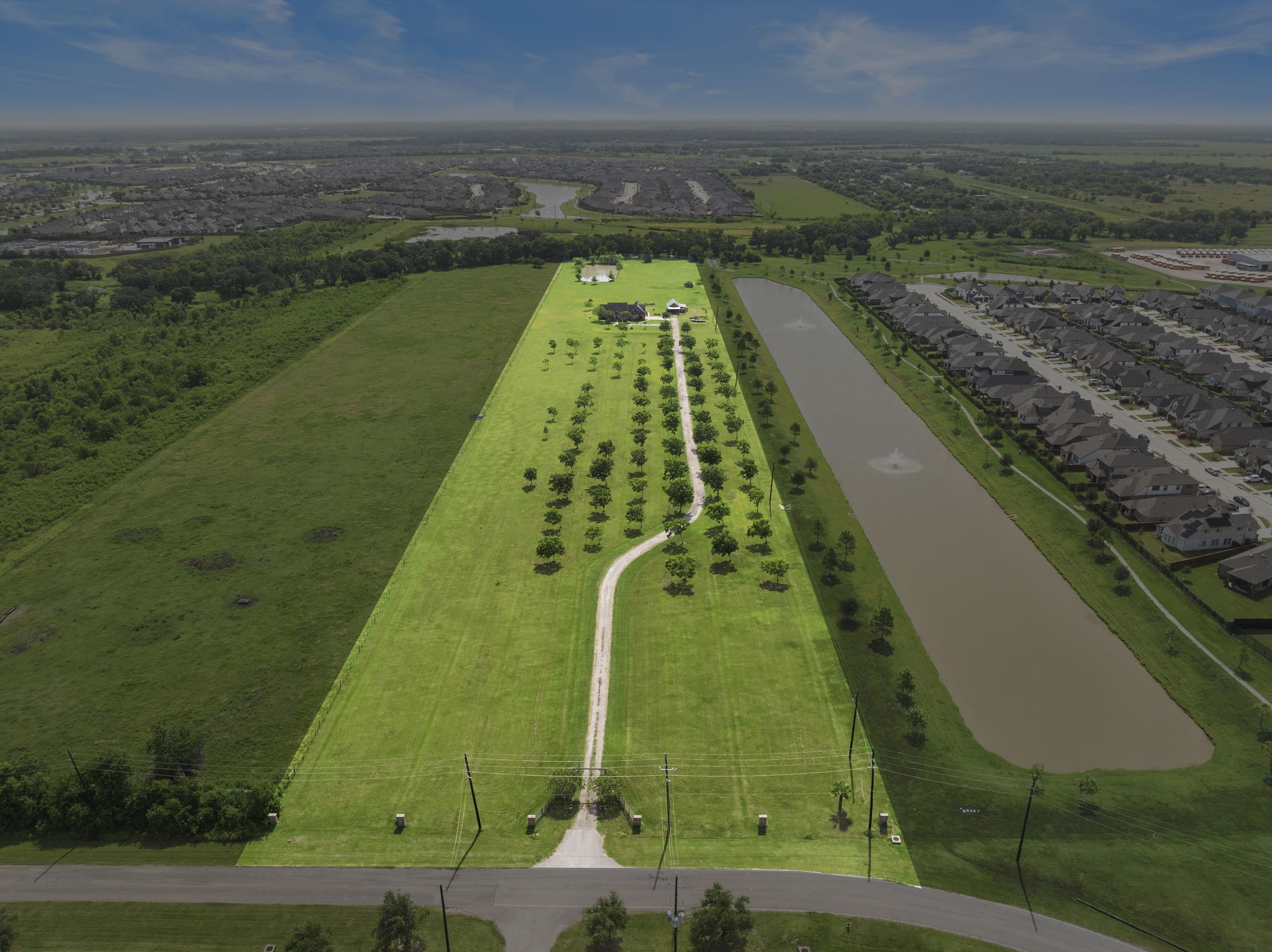 10411 County Road 65 Rosharon, TX 77583 - Photo 5 of 29 Pecan trees line the drive of the property, providing beauty and seasonal harvests while reinforcing the feeling of a spacious, country estate.