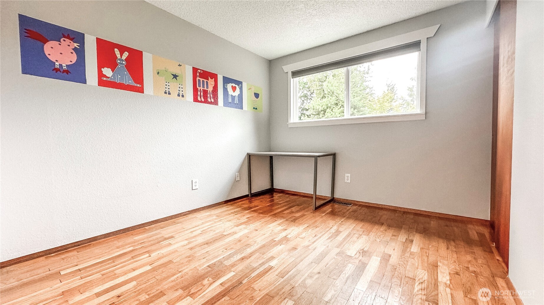 2830 216th Avenue Southeast Sammamish, WA 98075 - Photo 15 of 23 a view of an empty room with wooden floor and a window
