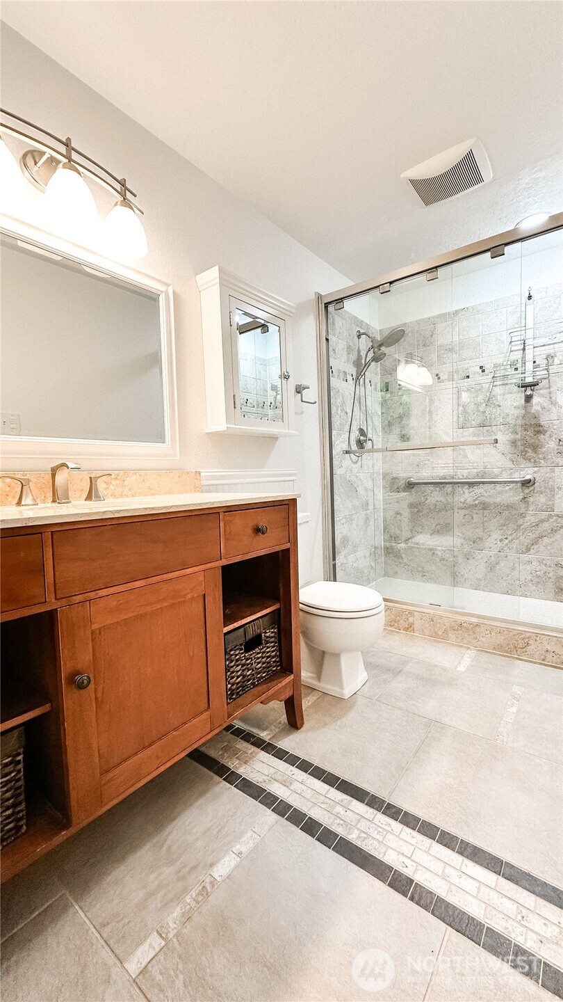 2830 216th Avenue Southeast Sammamish, WA 98075 - Photo 18 of 23 a bathroom with a sink a toilet and a shower