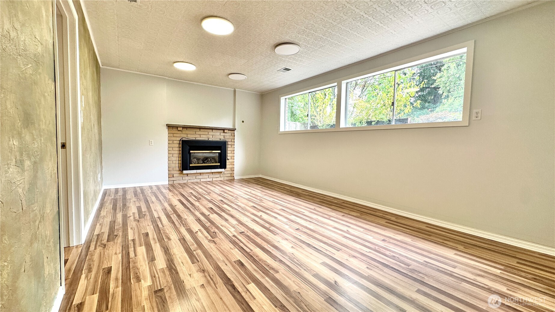 2830 216th Avenue Southeast Sammamish, WA 98075 - Photo 23 of 23 a bedroom with a bed and a fireplace