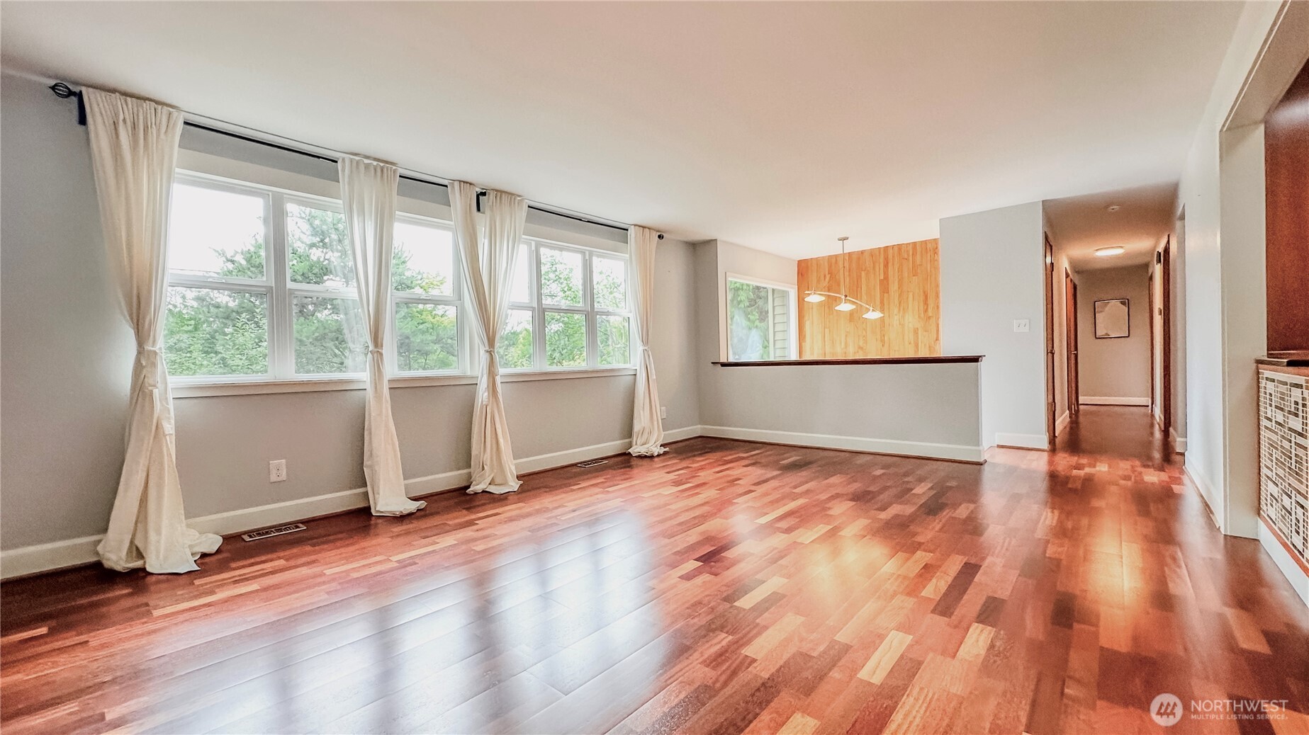2830 216th Avenue Southeast Sammamish, WA 98075 - Photo 4 of 23 an empty room with wooden floor and windows