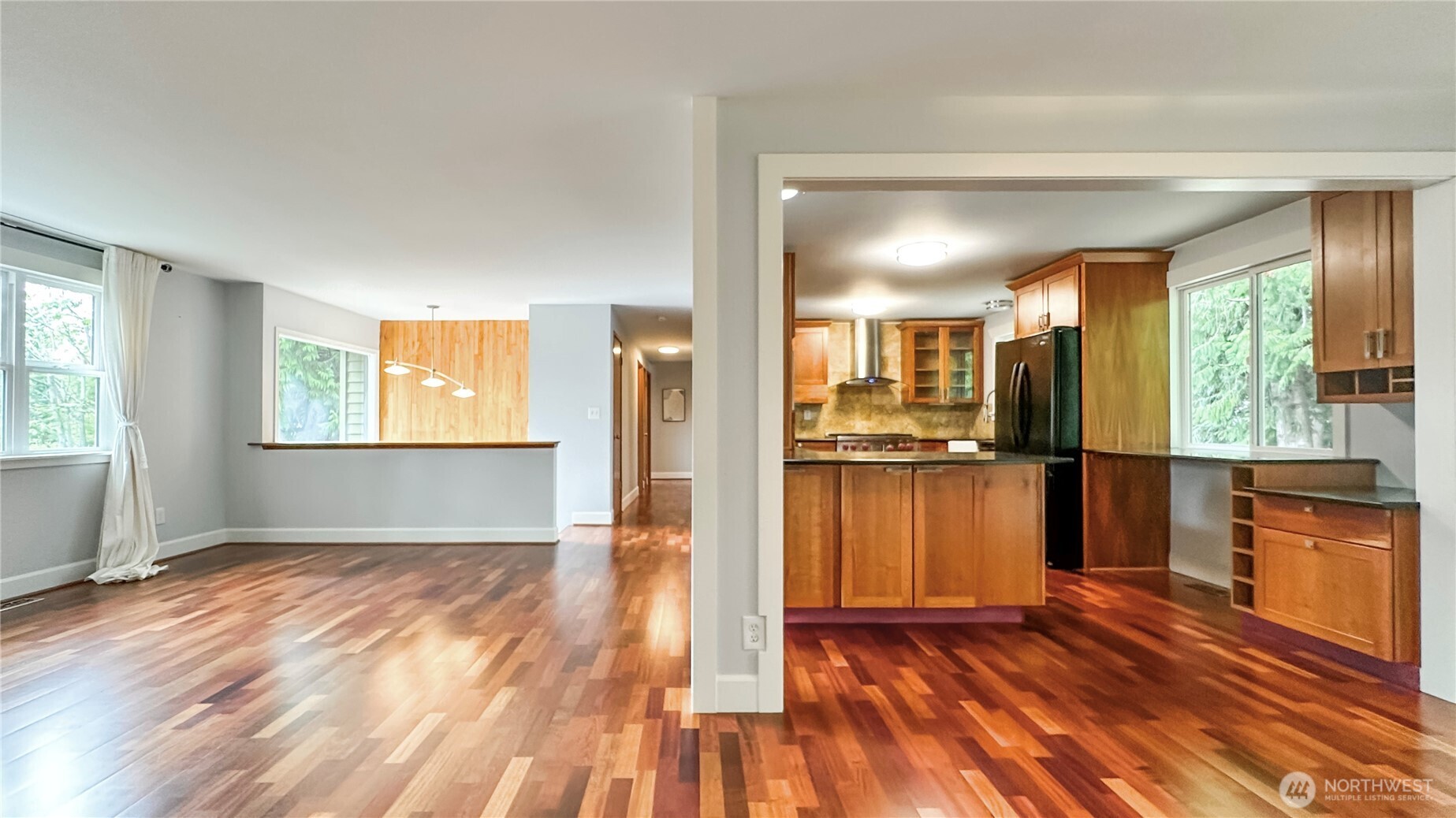 2830 216th Avenue Southeast Sammamish, WA 98075 - Photo 6 of 23 a view of a living room kitchen with hardwood floor and a window