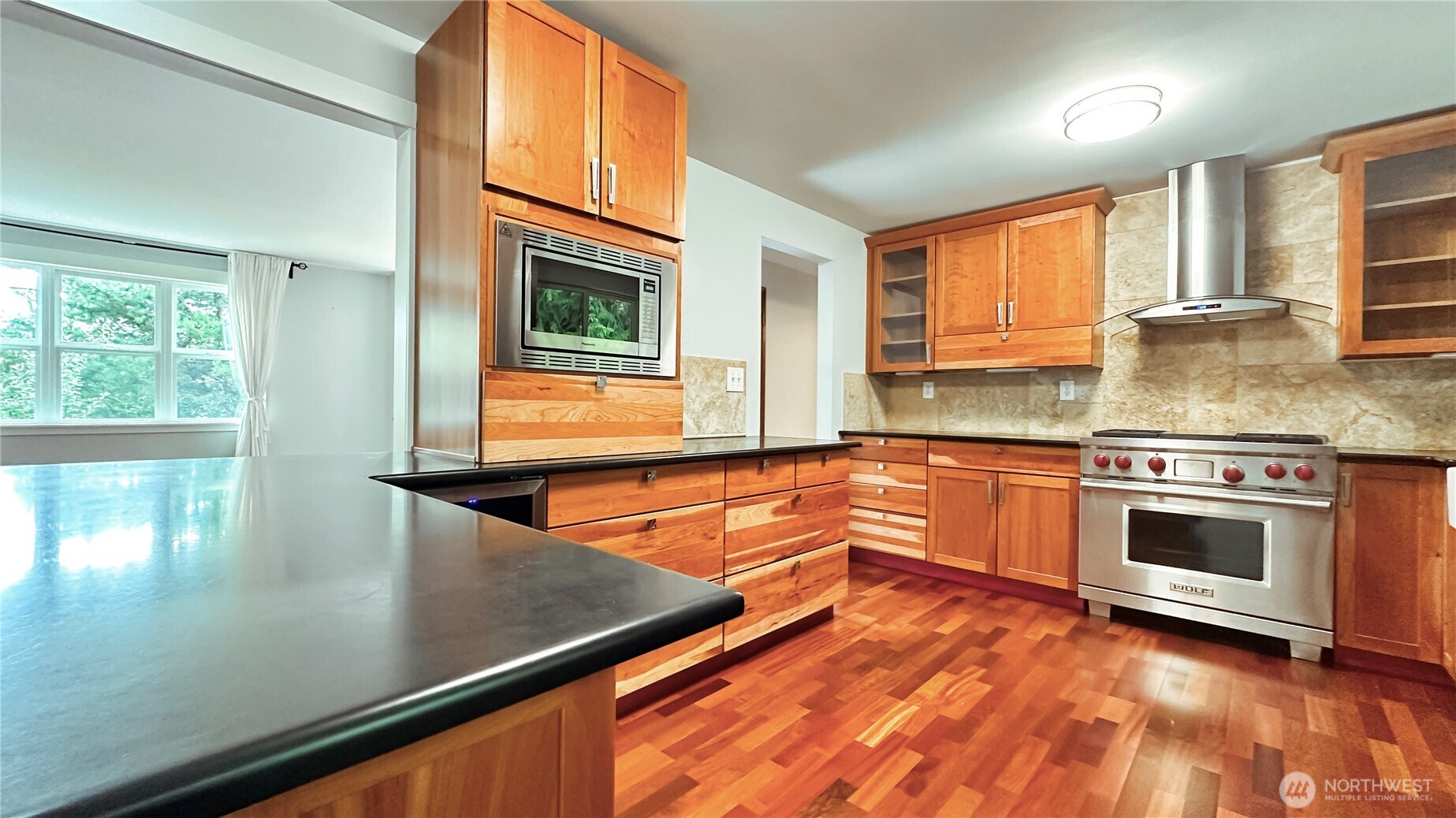 2830 216th Avenue Southeast Sammamish, WA 98075 - Photo 10 of 23 a kitchen with stainless steel appliances granite countertop a stove a sink and a microwave