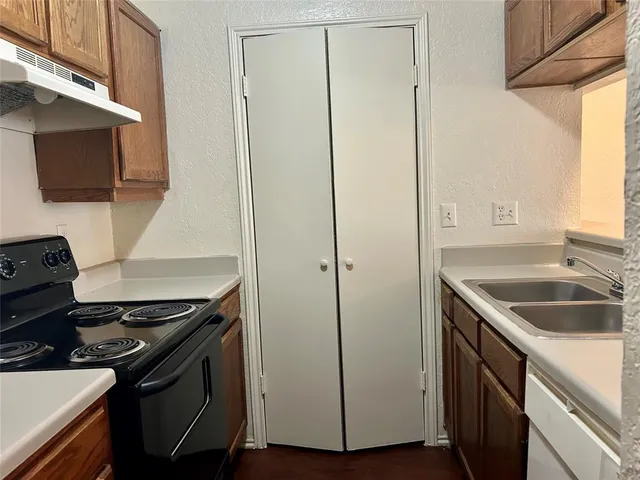 a kitchen that has a sink and a stove