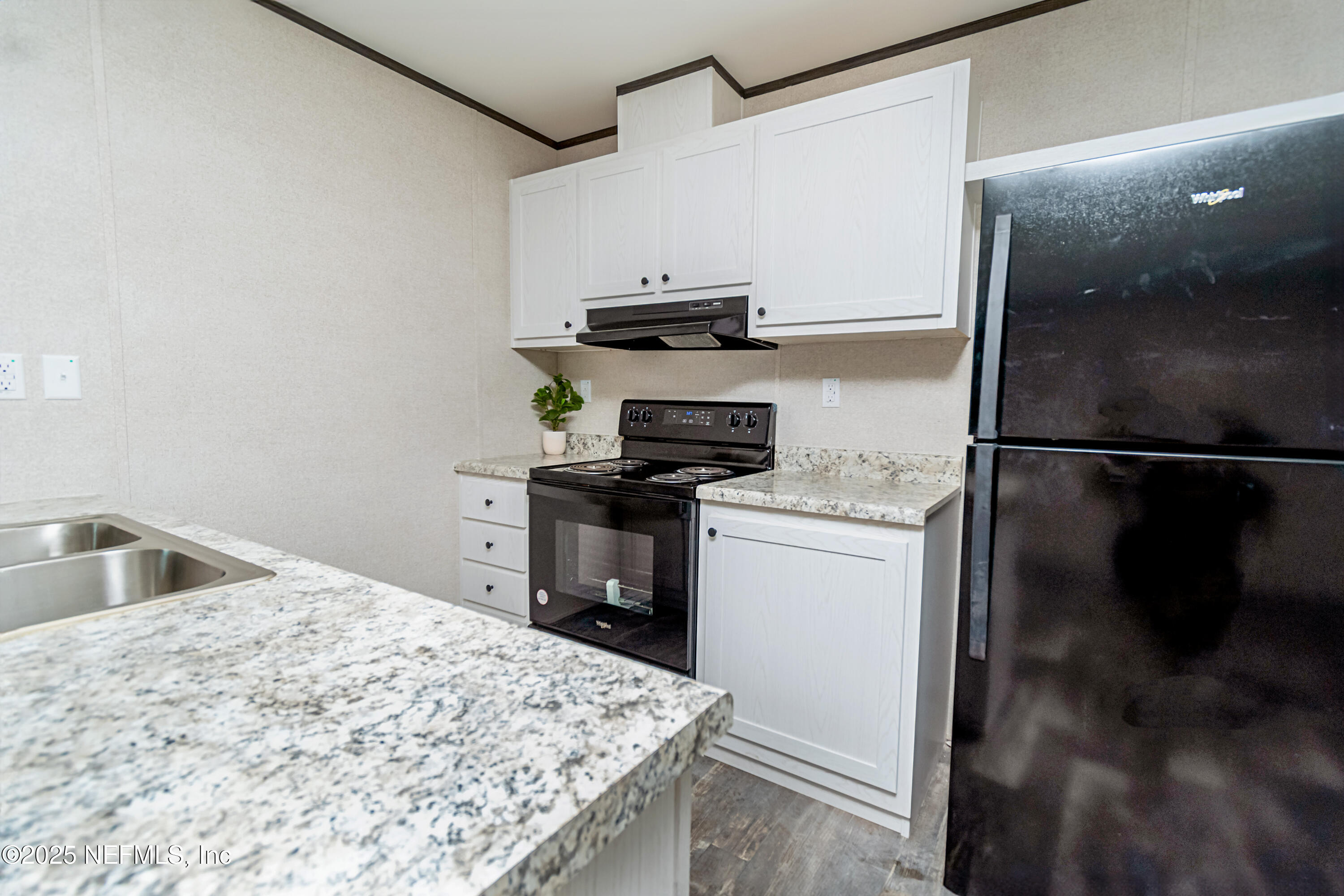 406 Sycamore Drive Macclenny, FL 32063 - Photo 5 of 22 a kitchen with a refrigerator and a sink