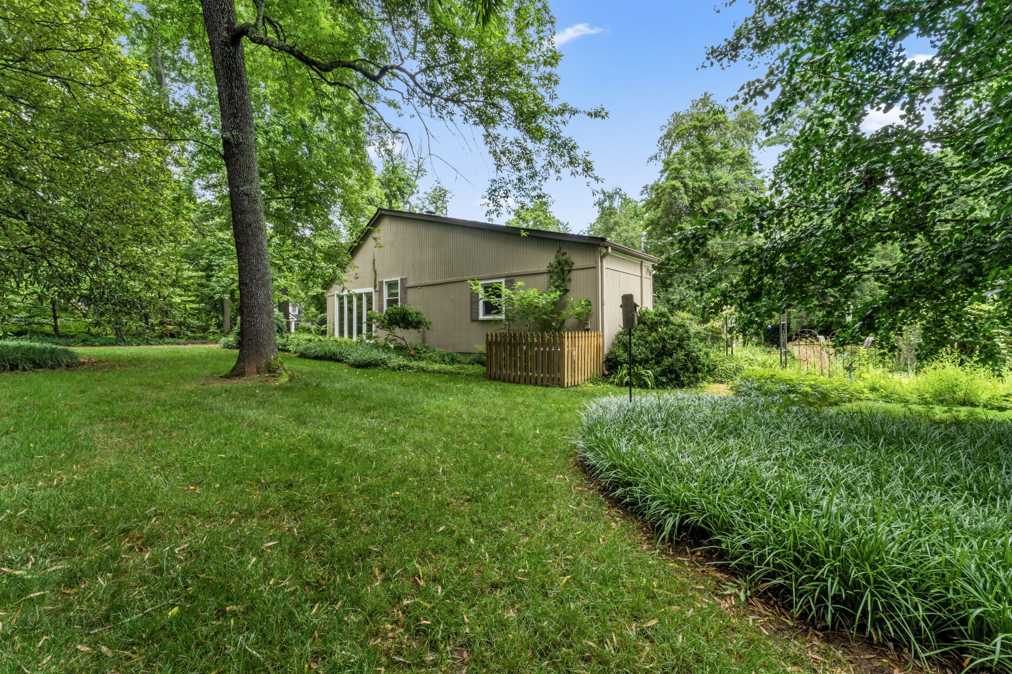 412 Page Road Nashville, TN 37205 - Photo 5 of 36 a view of a backyard with potted plants and large trees