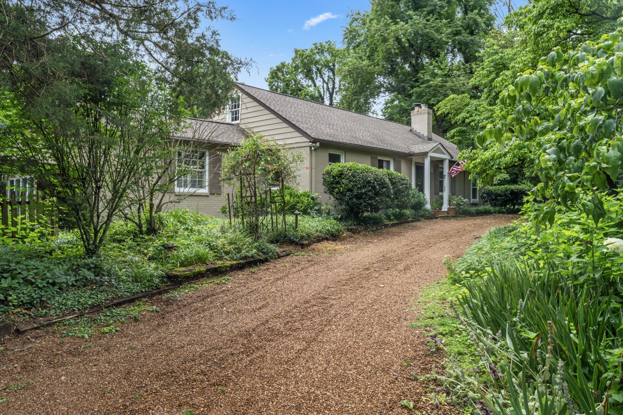412 Page Road Nashville, TN 37205 - Photo 8 of 36 a view of a white house with a big yard and potted plants