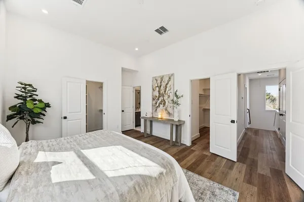 a bedroom with a bed and a potted plant
