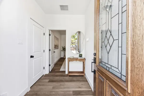 a hallway with wooden floor windows