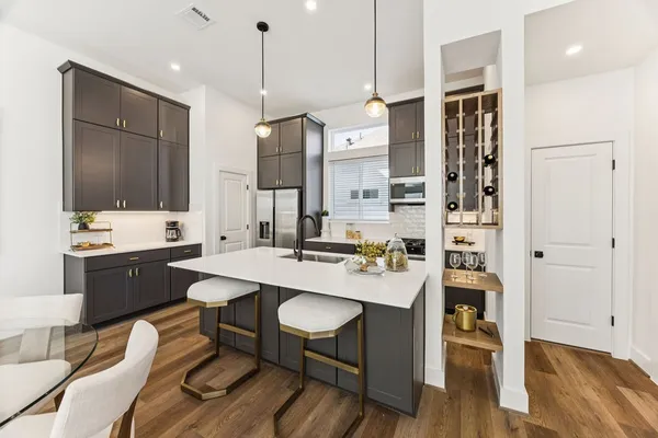 a large kitchen with a table and chairs