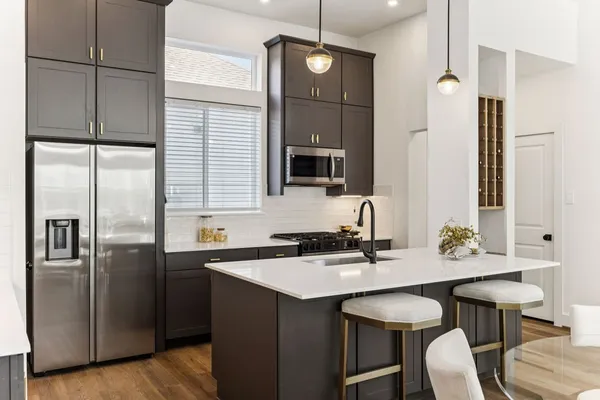 a kitchen with a sink refrigerator and microwave