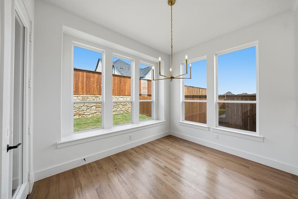205 Ardsley Way Allen, TX 75013 - Photo 11 of 37 a view of an empty room with a window and wooden floor