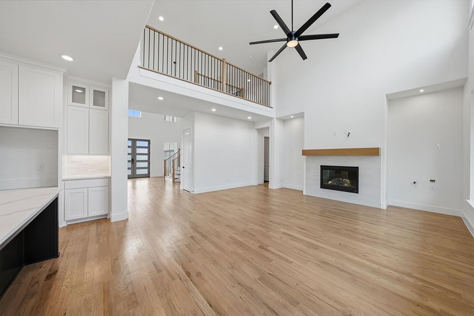 205 Ardsley Way Allen, TX 75013 - Photo 13 of 37 a view of empty room with wooden floor and fireplace