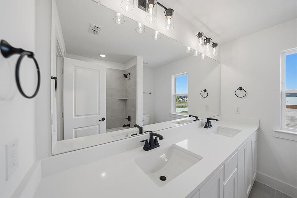 205 Ardsley Way Allen, TX 75013 - Photo 25 of 37 a bathroom with a sink a mirror and a shower