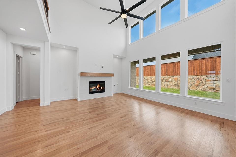 205 Ardsley Way Allen, TX 75013 - Photo 8 of 37 a view of empty room with wooden floor and fireplace