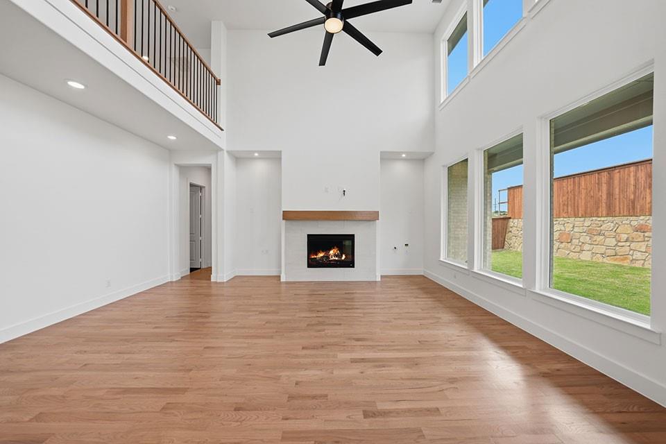 205 Ardsley Way Allen, TX 75013 - Photo 9 of 37 a view of an empty room with a fireplace and a window