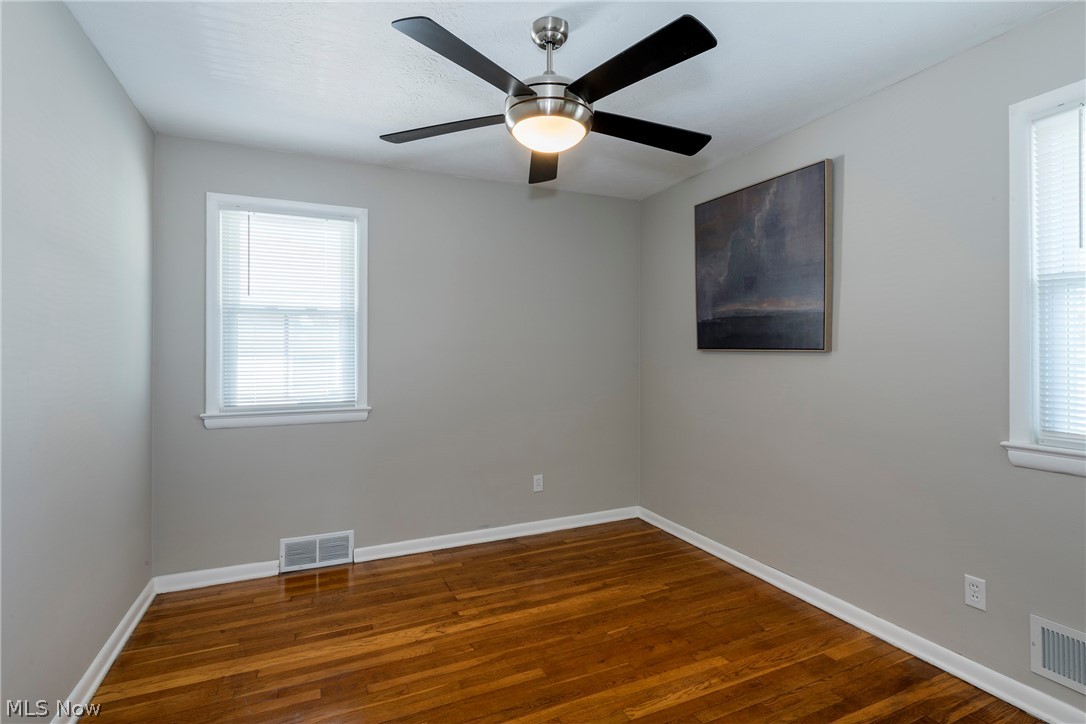 13175 McCracken Road Cleveland, OH 44125 - Photo 17 of 48 Bedroom with a healthy amount of sunlight, ceiling fan, and hardwood / wood-style flooring