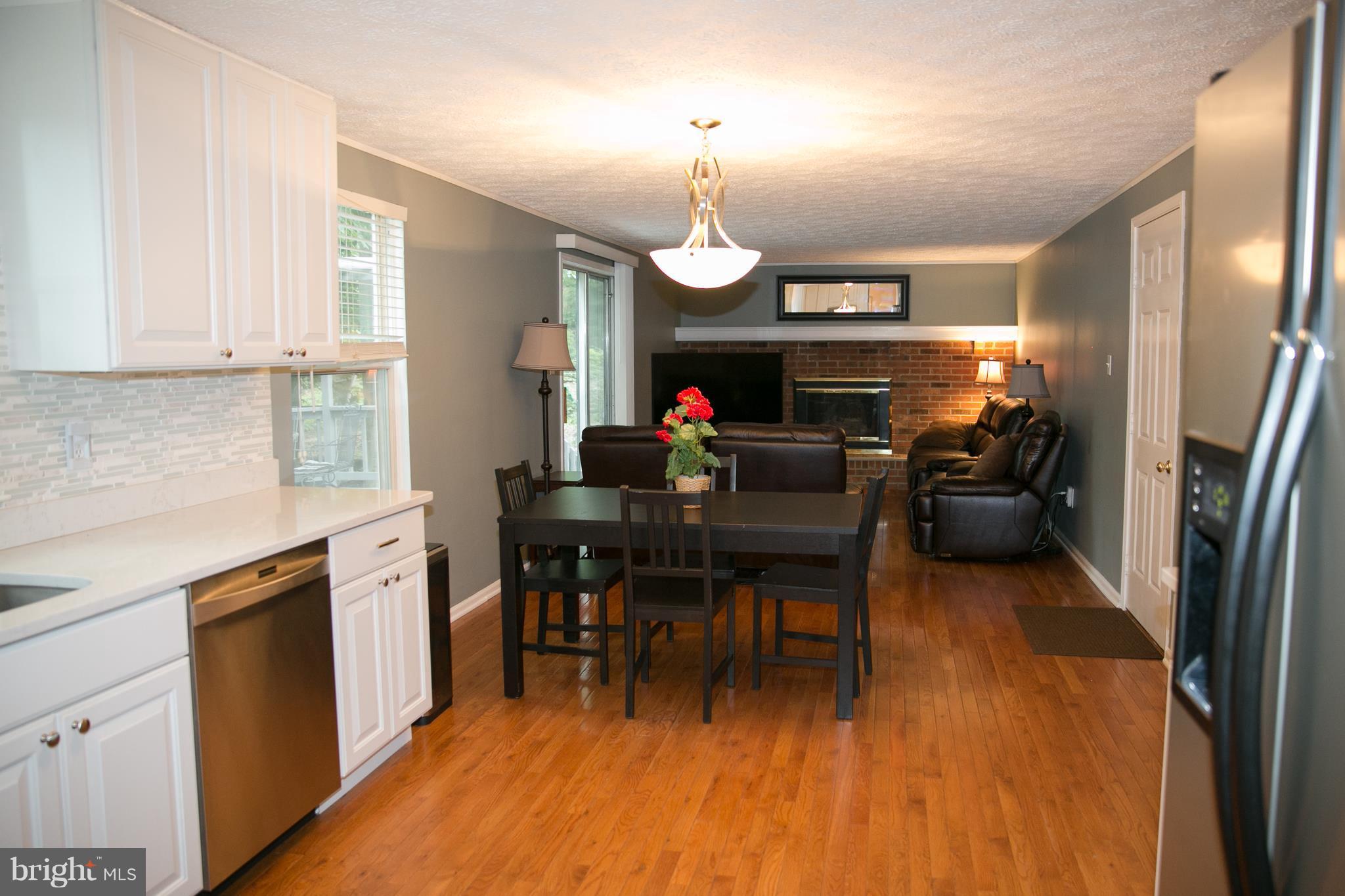 7835 Roundabout Way Springfield, VA 22153 - Photo 26 of 26 a kitchen with sink cabinets and dining table