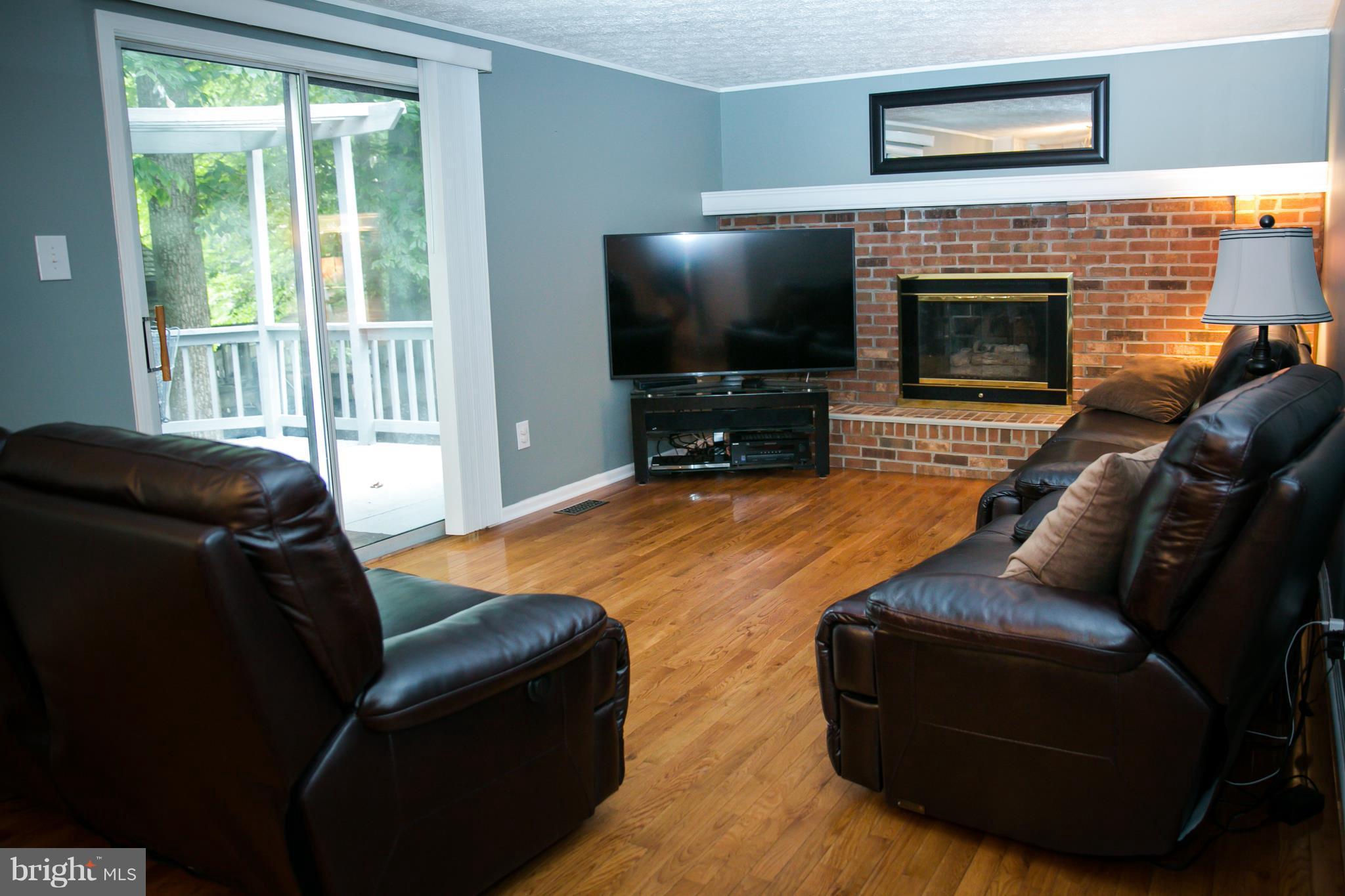 7835 Roundabout Way Springfield, VA 22153 - Photo 11 of 26 a living room with furniture and a flat screen tv