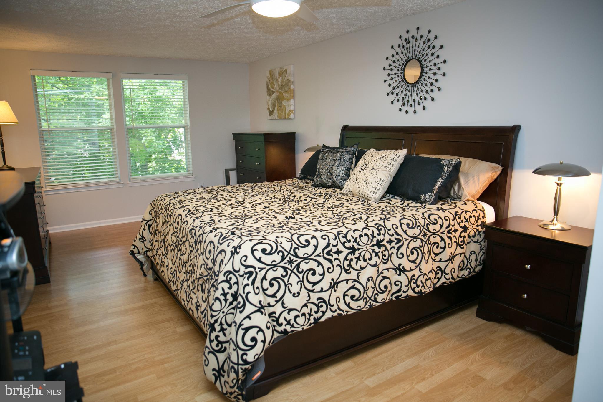 7835 Roundabout Way Springfield, VA 22153 - Photo 15 of 26 a bed sitting in a bedroom next to a window
