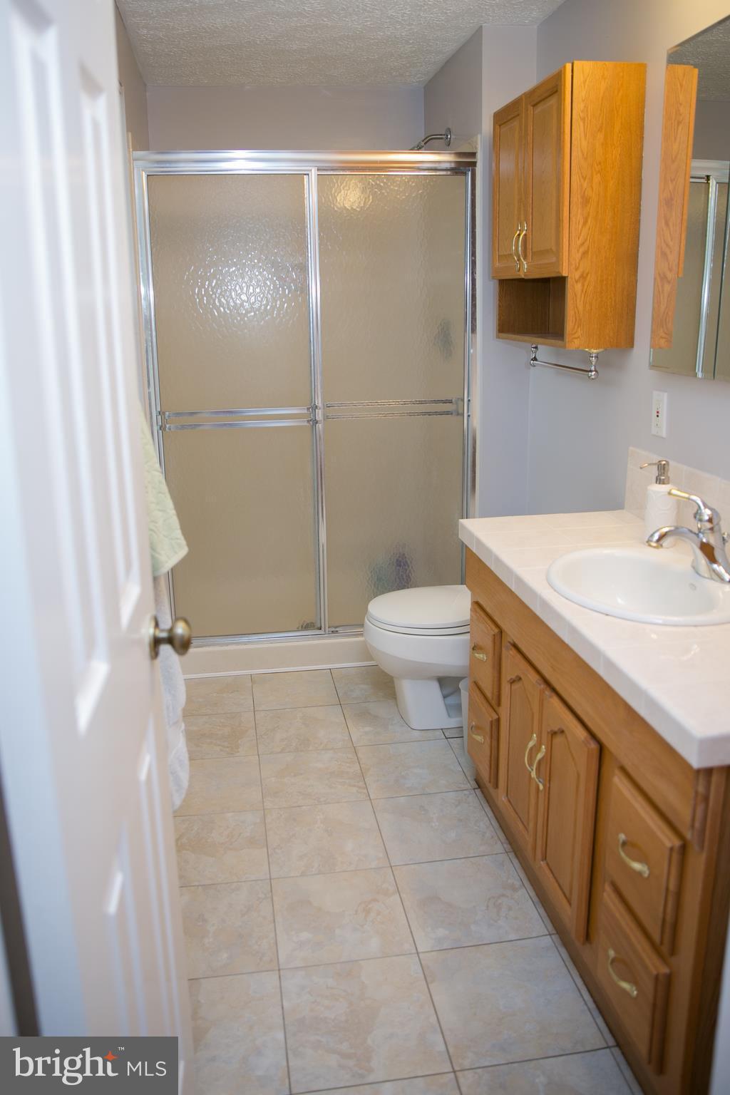 7835 Roundabout Way Springfield, VA 22153 - Photo 16 of 26 a bathroom with a sink a toilet and shower