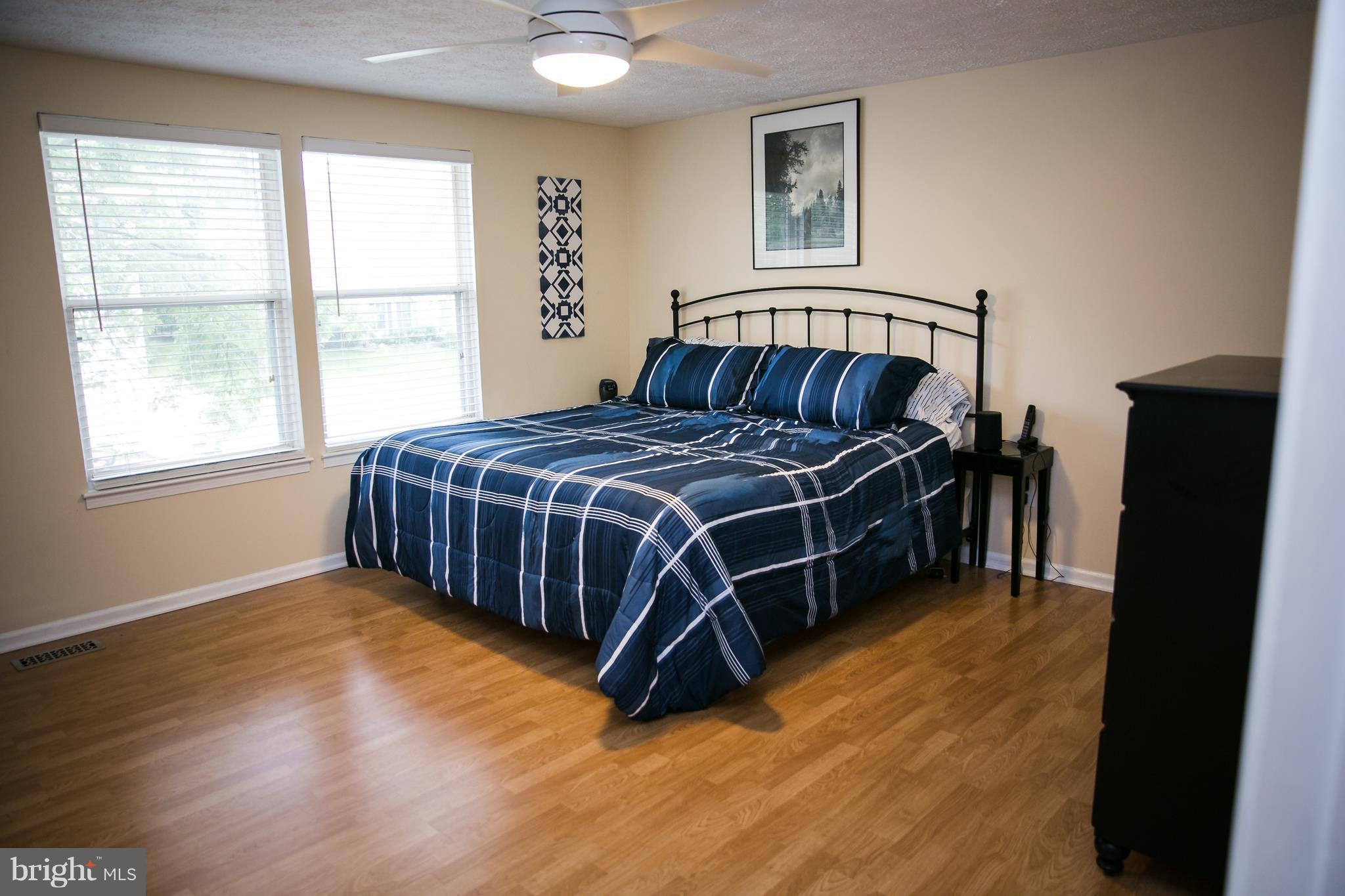 7835 Roundabout Way Springfield, VA 22153 - Photo 18 of 26 a bed sitting in a bedroom next to a window
