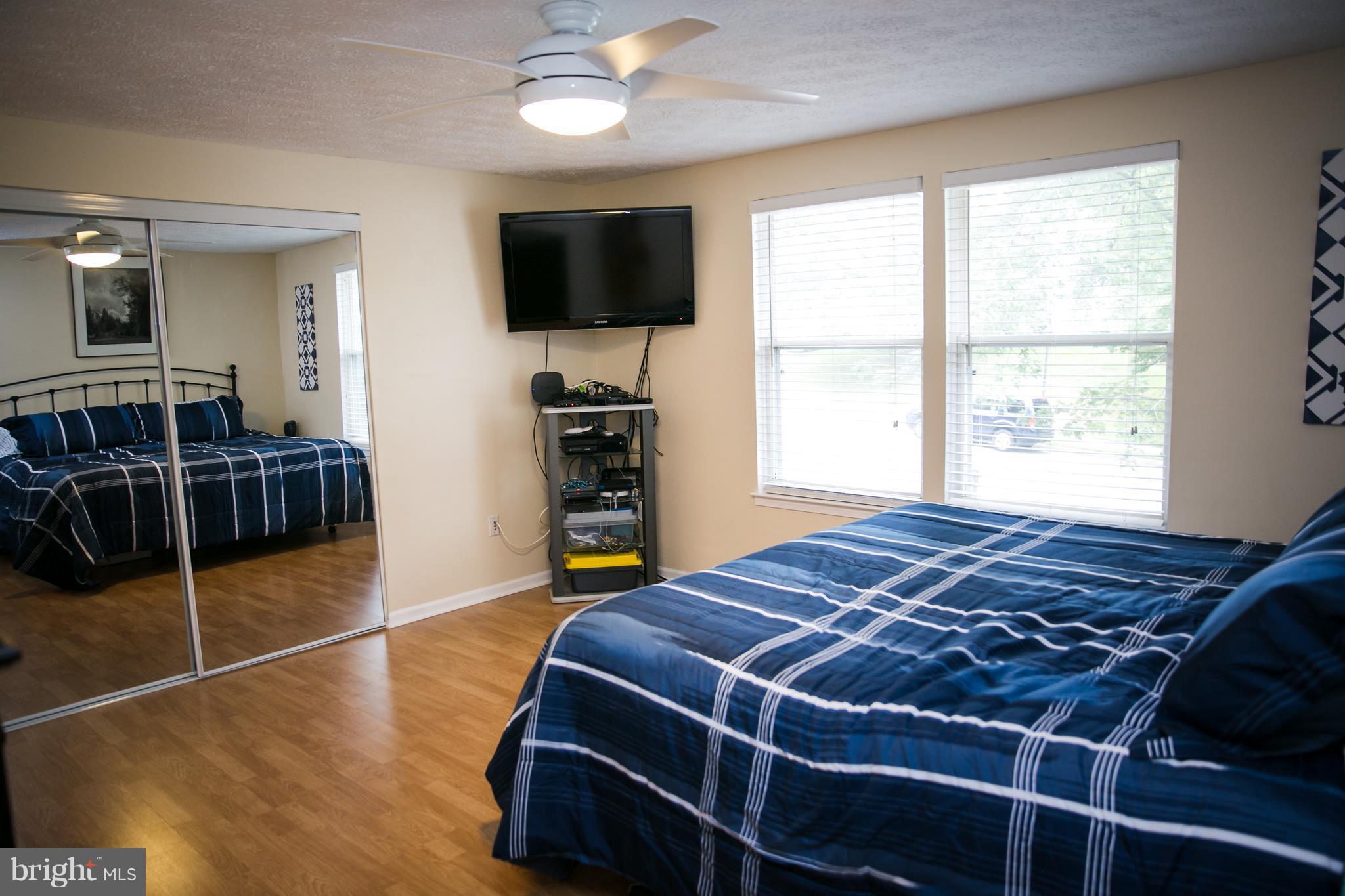 7835 Roundabout Way Springfield, VA 22153 - Photo 19 of 26 a bed sitting in a bedroom next to a window