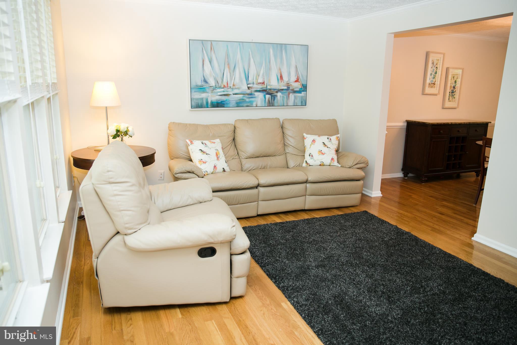 7835 Roundabout Way Springfield, VA 22153 - Photo 3 of 26 a living room with furniture and a couch