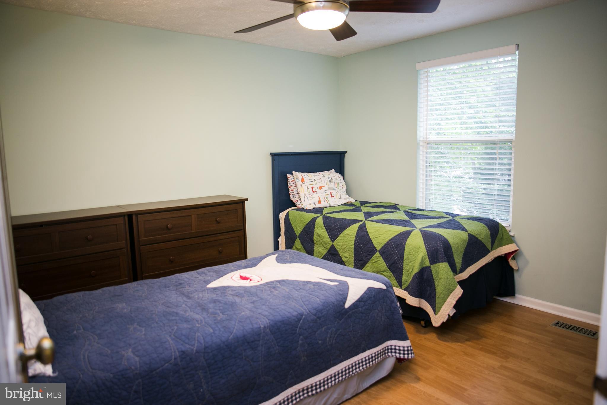 7835 Roundabout Way Springfield, VA 22153 - Photo 20 of 26 a bedroom with a bed and dresser
