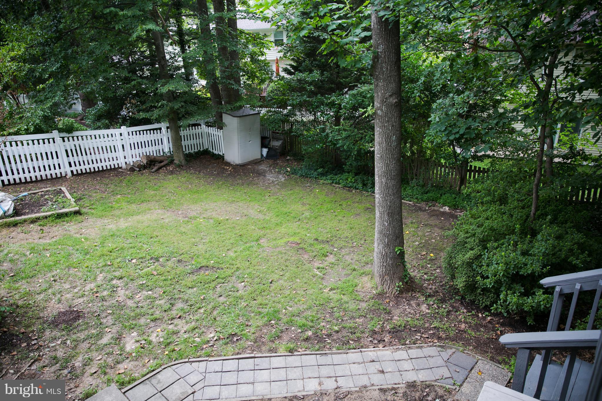 7835 Roundabout Way Springfield, VA 22153 - Photo 23 of 26 a view of a garden with a bench