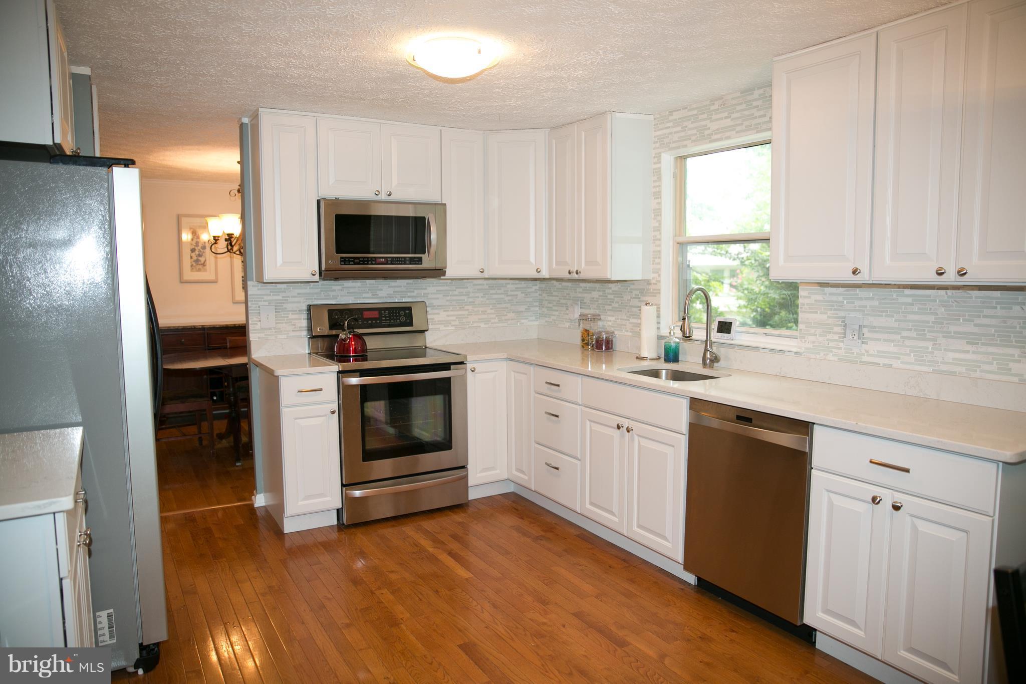 7835 Roundabout Way Springfield, VA 22153 - Photo 8 of 26 a kitchen with a sink stove top oven and refrigerator
