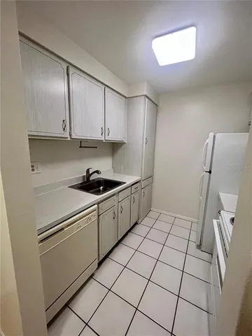 a white stove top oven sitting inside of a kitchen