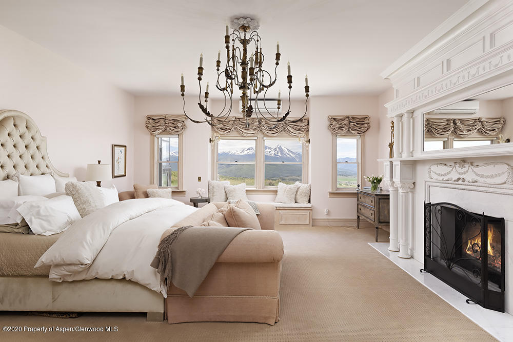 880 Buck Point Road Carbondale, CO 81623 - Photo 14 of 40 a bedroom with a bed and a fireplace