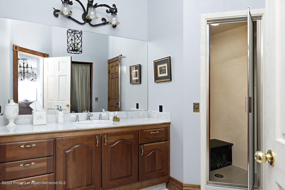 880 Buck Point Road Carbondale, CO 81623 - Photo 16 of 40 a bathroom with a sink and a mirror