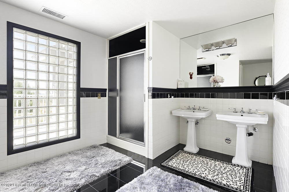 880 Buck Point Road Carbondale, CO 81623 - Photo 19 of 40 a bathroom with a sink a mirror and shower