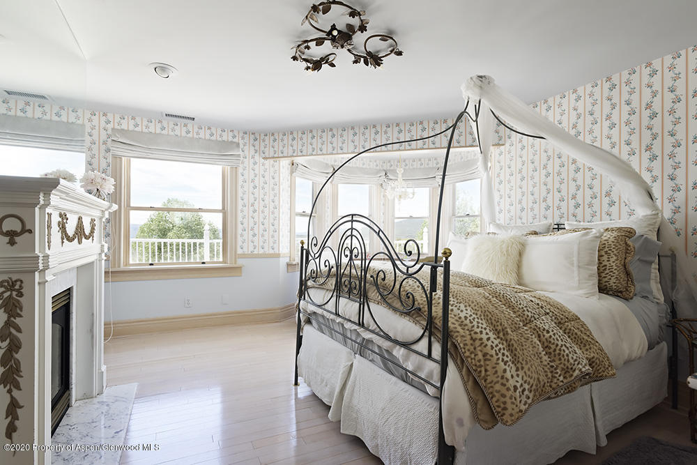 880 Buck Point Road Carbondale, CO 81623 - Photo 21 of 40 a bed sitting in a bedroom next to a window