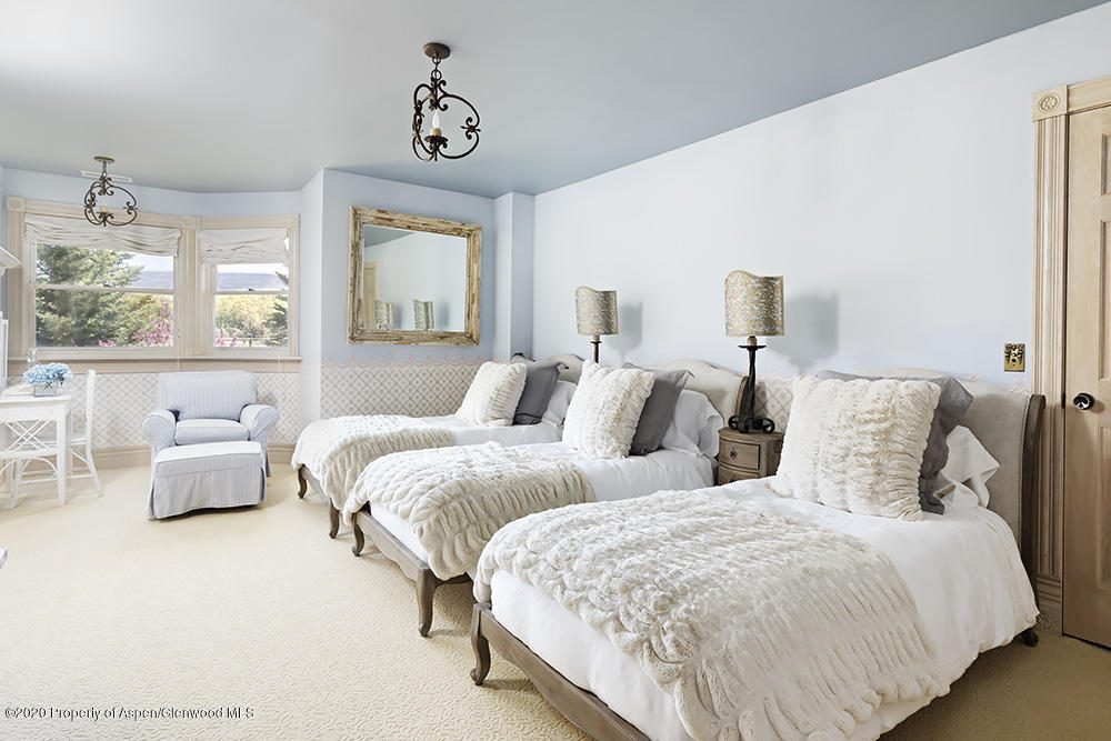 880 Buck Point Road Carbondale, CO 81623 - Photo 22 of 40 a bedroom with two beds and a large window