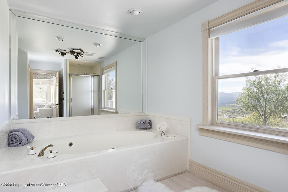880 Buck Point Road Carbondale, CO 81623 - Photo 23 of 40 a bathroom with a tub a sink and a window