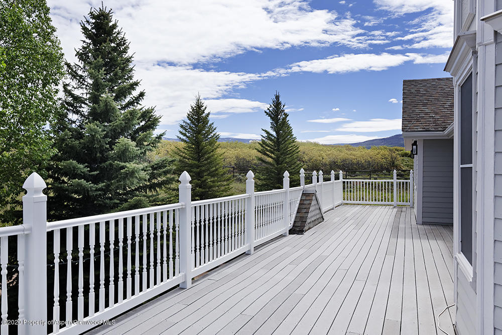 880 Buck Point Road Carbondale, CO 81623 - Photo 37 of 40 a view of a roof deck with wooden floor and fence