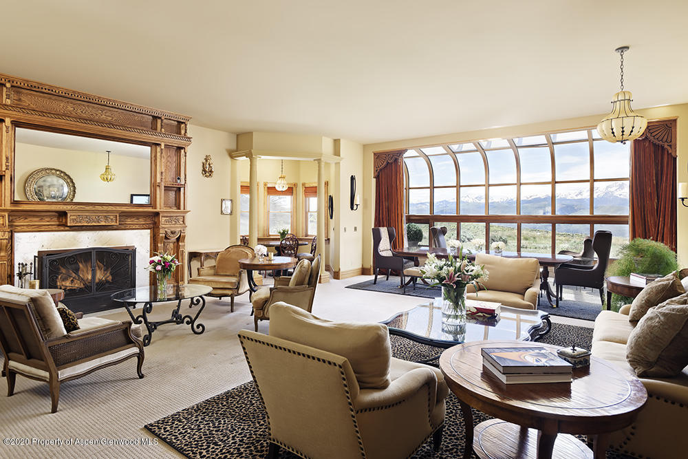 880 Buck Point Road Carbondale, CO 81623 - Photo 4 of 40 a living room with furniture large window and a fireplace