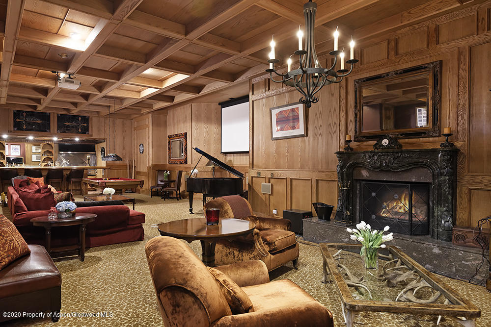 880 Buck Point Road Carbondale, CO 81623 - Photo 9 of 40 a living room with patio furniture and a fireplace