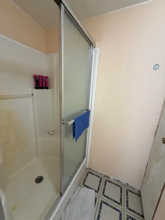 a bathroom with a shower and sink