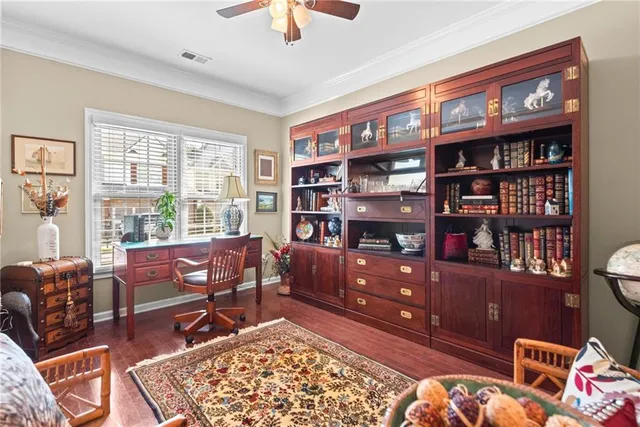 a living room with furniture a rug and a book shelf