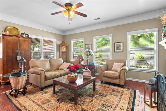 a living room with furniture fireplace and a large window